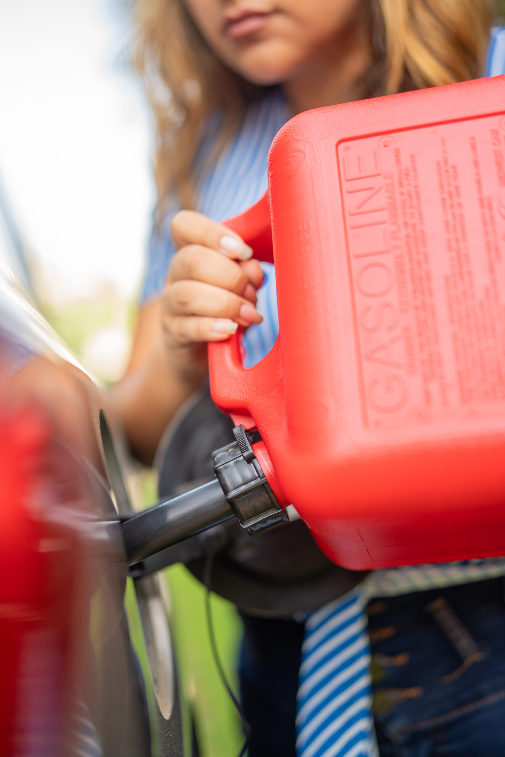 Female rescuer filling a car with gas