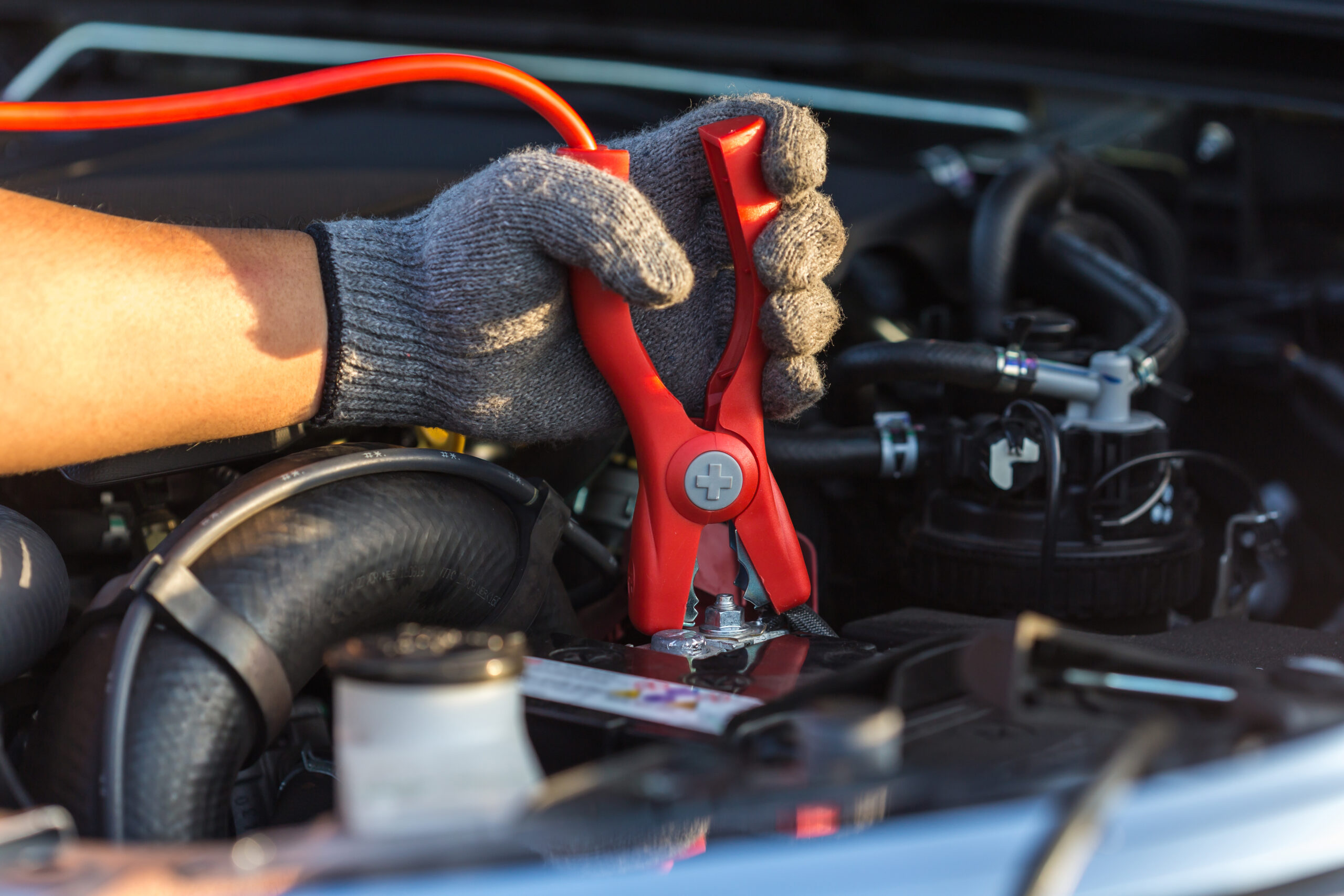 Jumper cables being hooked on a car