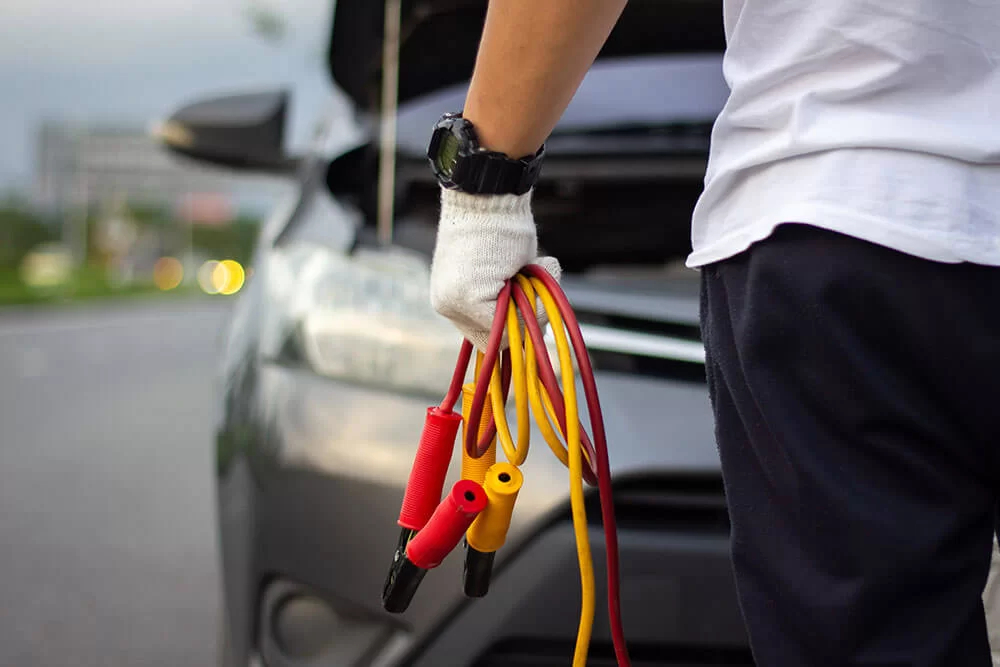 Jumper cables wrapped up and being taken to car