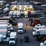 Trucks and equipment in a yard.